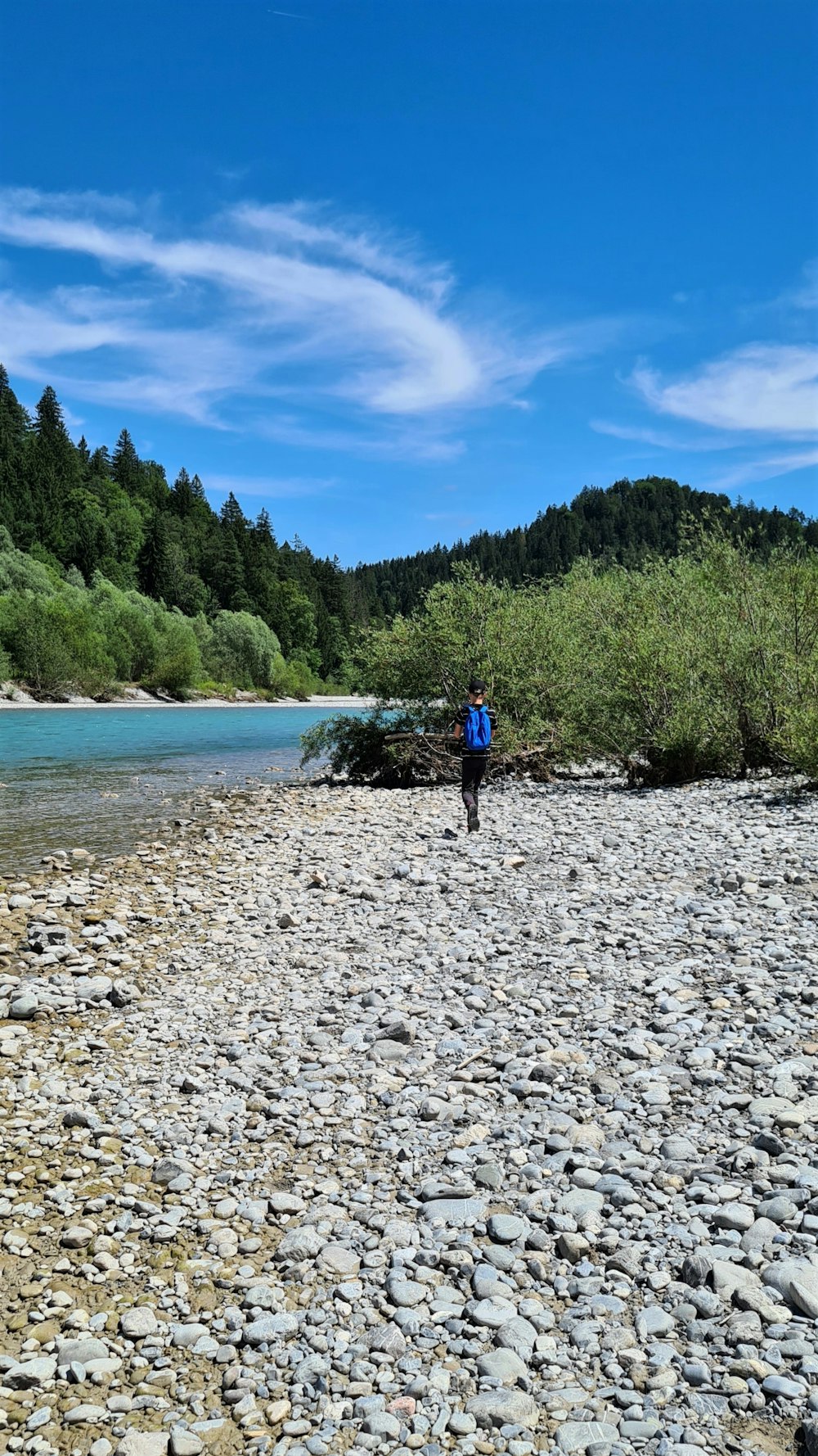 a person standing on a rocky shore