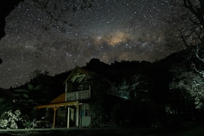 Evening view of the tiny house lit up under the stars.