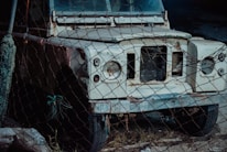a white bus with a rusted front bumper