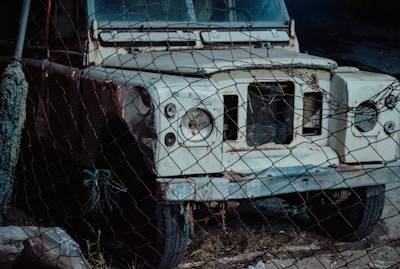 a white bus with a rusted front bumper