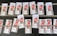 Several rows of paper tickets are arranged on a flat dark surface. Each ticket features a prominent red design with text and barcodes. The tickets are grouped in sets with handwritten labels above them, displaying numbers like '5218', '5216', and others.