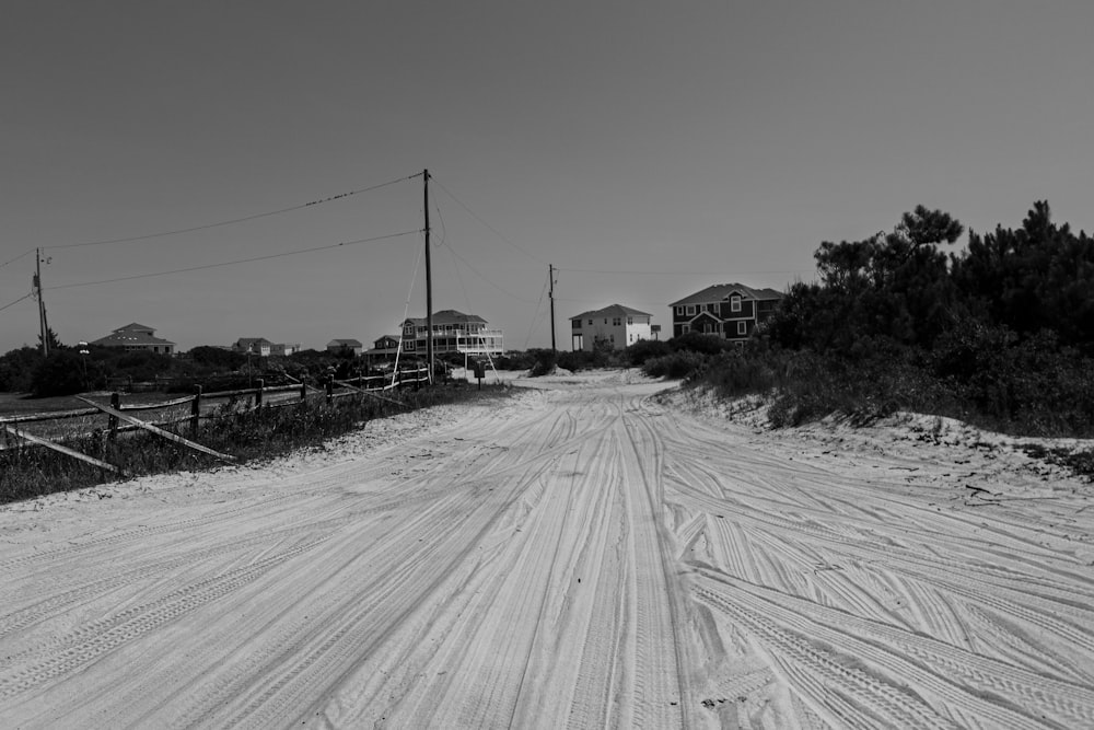 a road with a fence and trees on the side