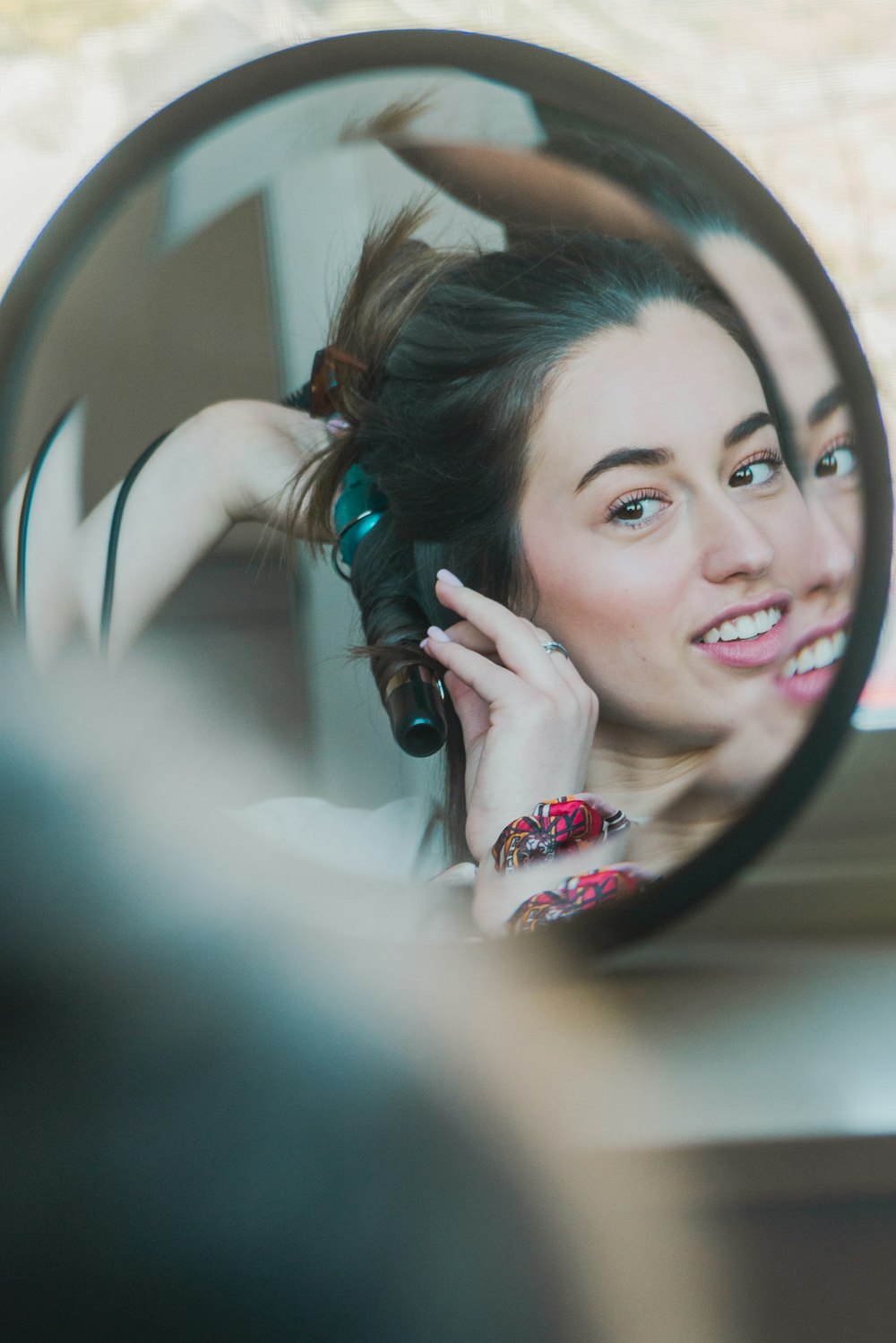 a woman looking through a mirror