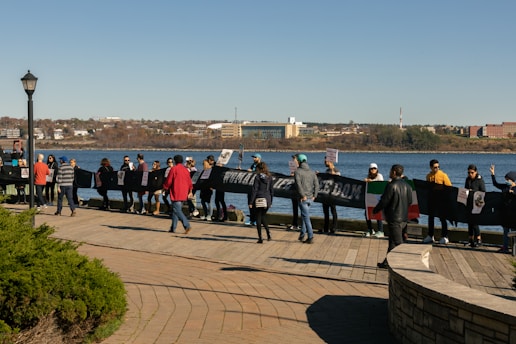 A group of diverse people holding 'Partidul Far' banners during a community event.