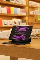 An iPad with a new battery being installed by a focused technician.
