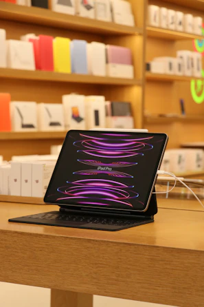 An iPad with a new battery being installed by a focused technician.