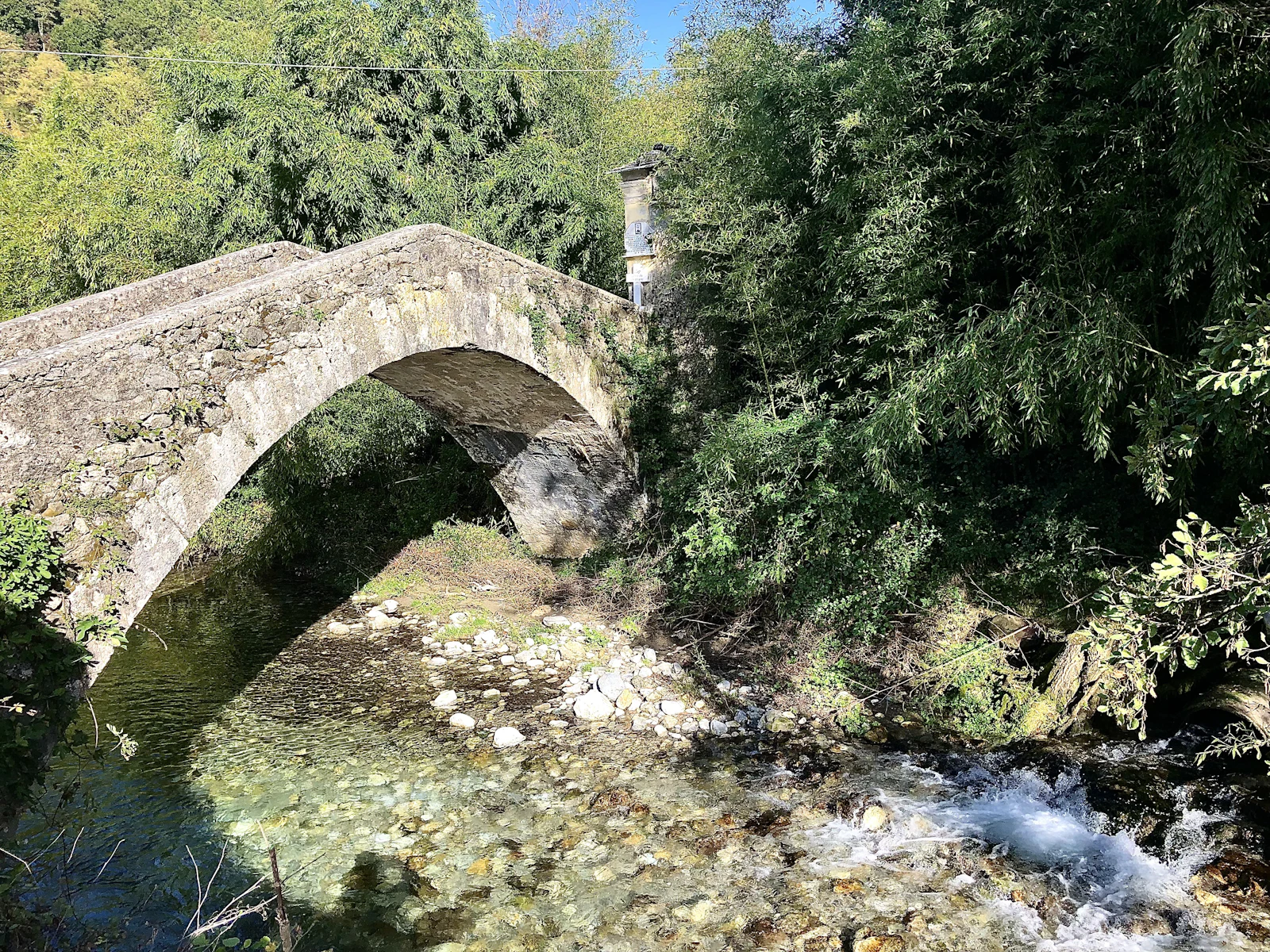 Old stone bridge over a river in Lunigiana