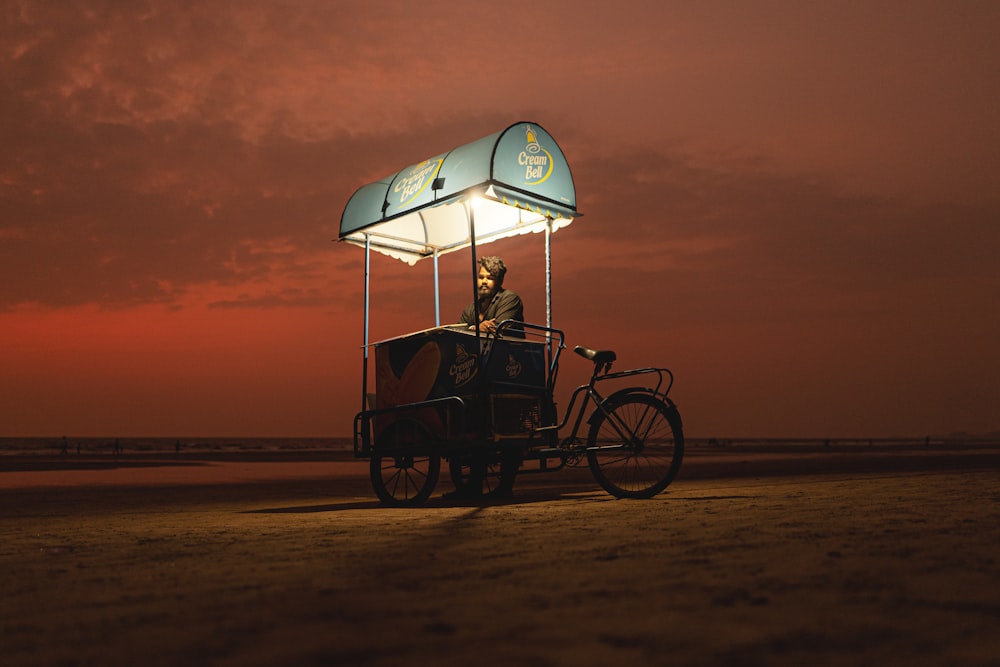 a person riding a bicycle with an umbrella on the back