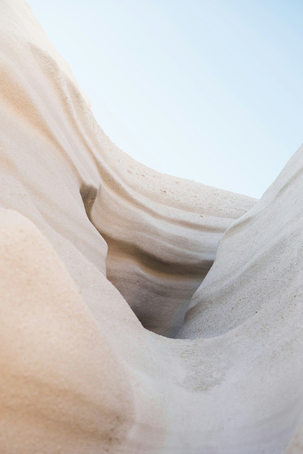 a sand dune with a blue sky