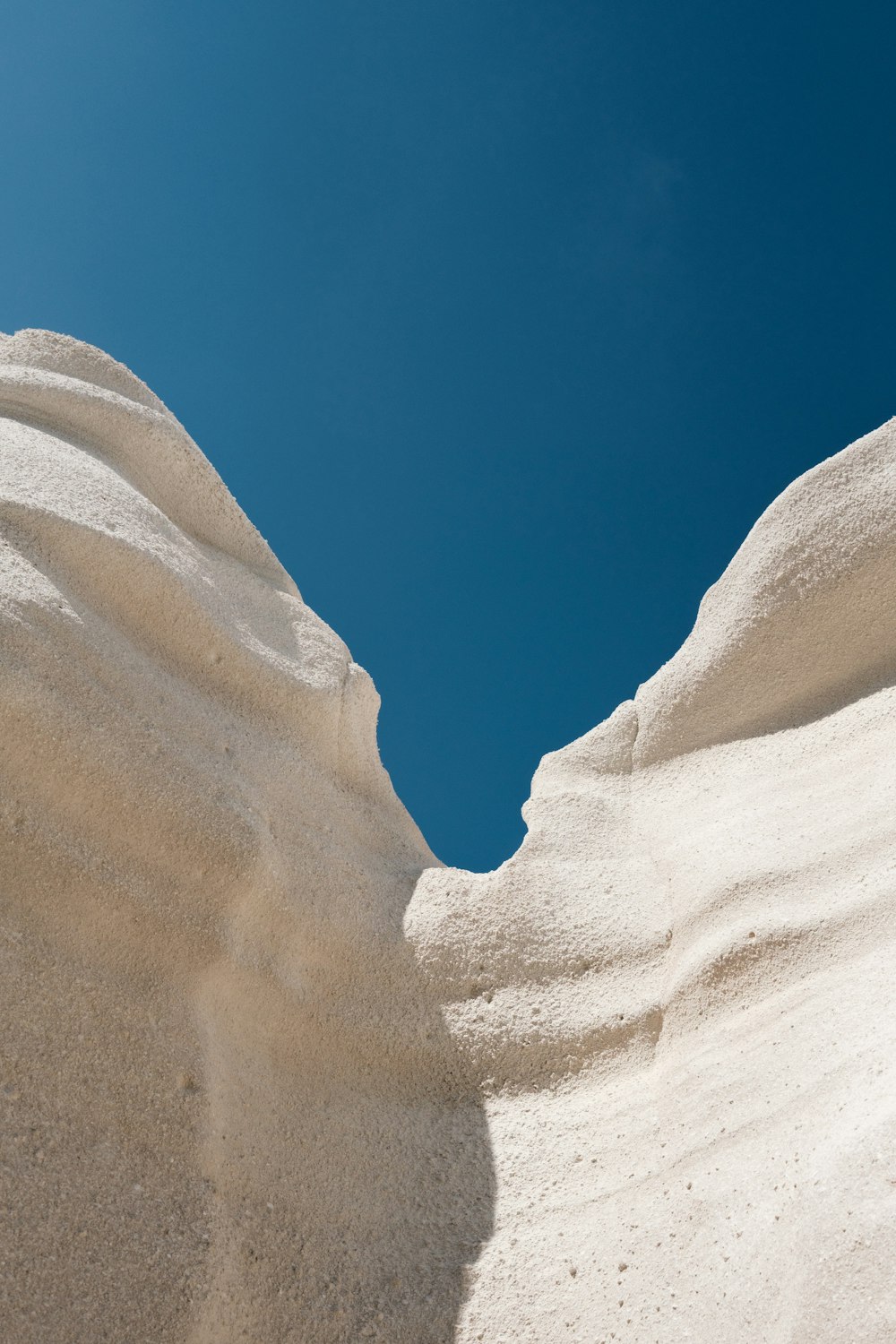 a sandy desert with a blue sky