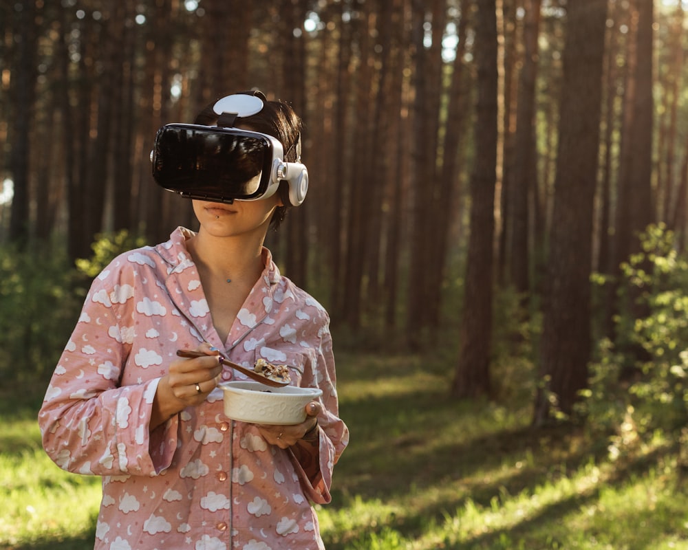 a person wearing a mask and holding a bowl of food