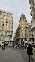 A vibrant cityscape of a European capital bustling with innovation and diverse people.