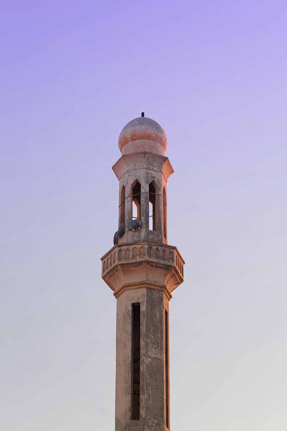 a tall tower with a round top with Beach Lighthouse in the background