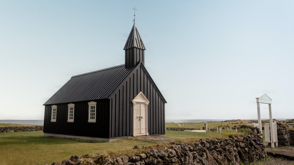 a black and white building with a cross on top