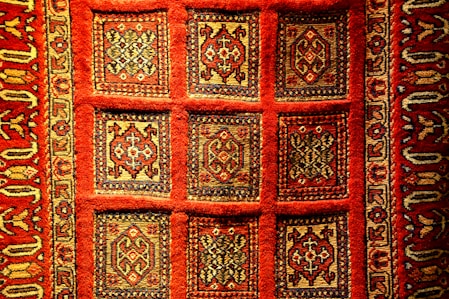 a red rug with designs