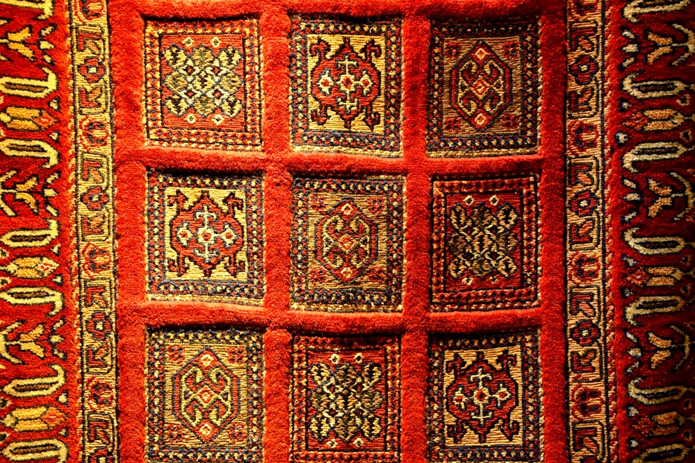 a red rug with designs