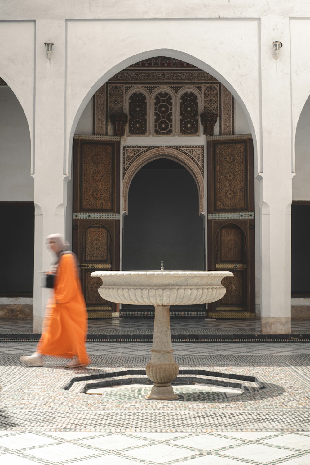 a person standing next to a fountain