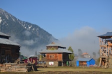 a group of buildings with mountains in the background