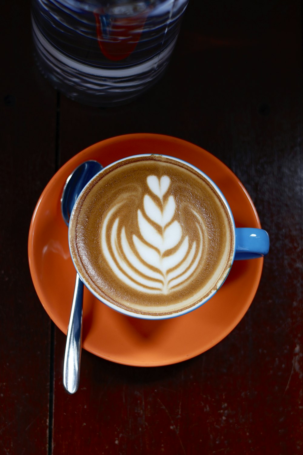 a cup of coffee with a design on the foam