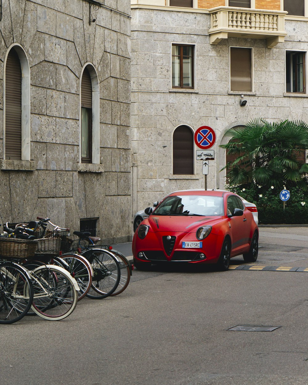 a red car parked on the side of a street