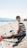 a man sitting on a beach