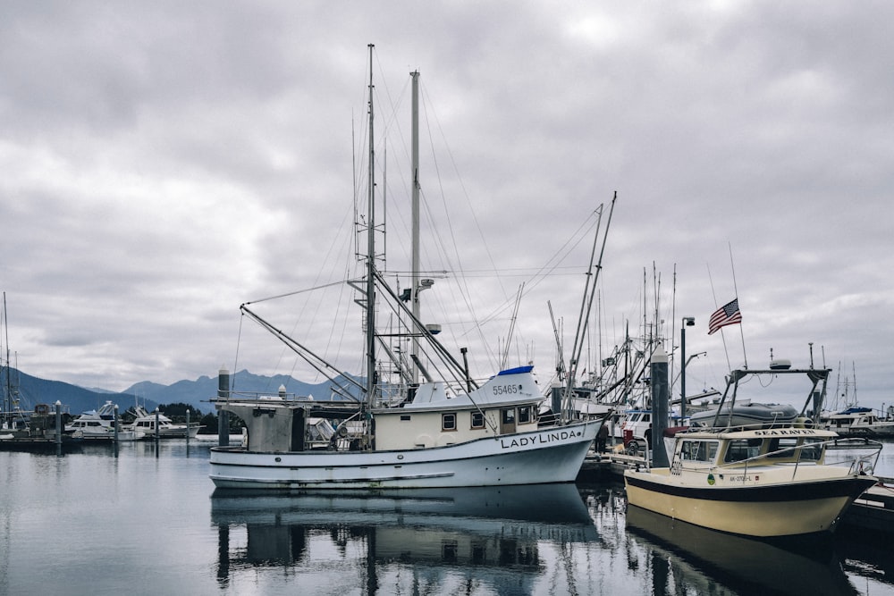 a couple of boats sit in a harbor