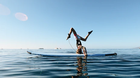 a man doing a flip into the water