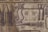 The image depicts an ancient Egyptian hieroglyphic scene featuring figures with humanoid bodies and animal heads, alongside snakes and abstract symbols. The artwork is inscribed on a worn, stone-like surface.