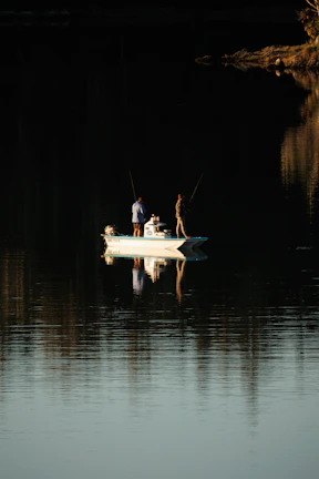 a group of people stand on a boat in the water