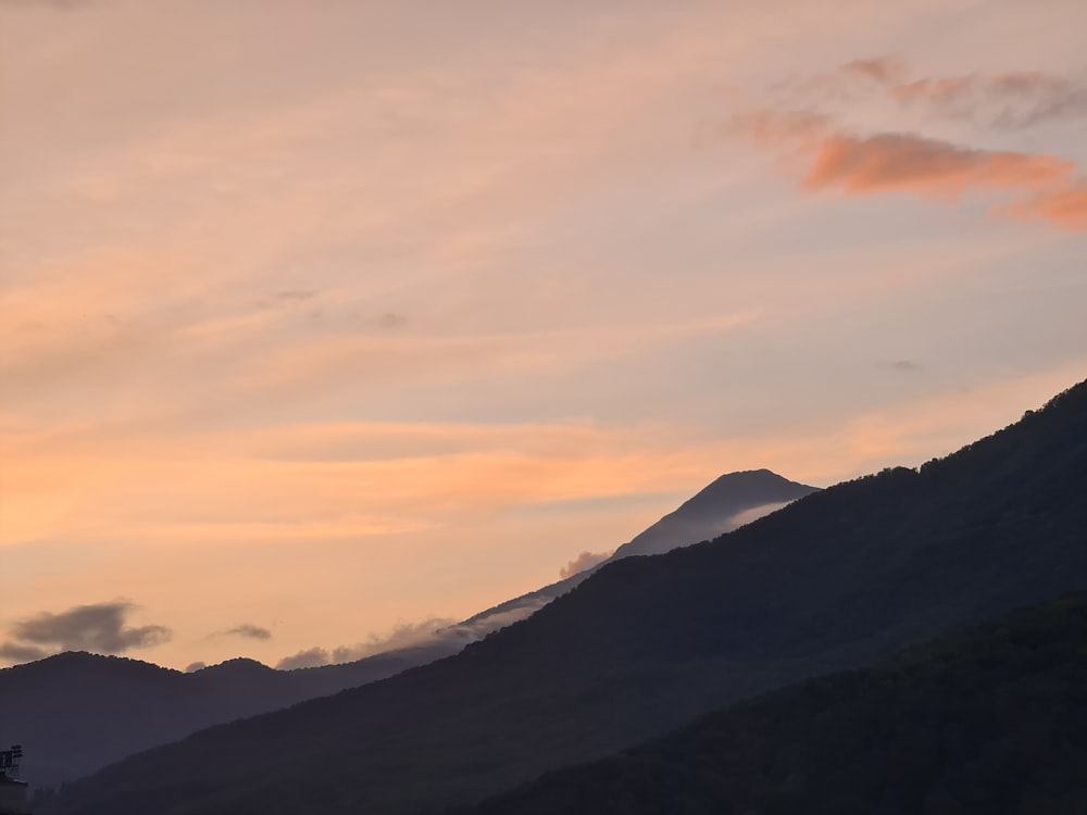 a mountain with a sunset in the background