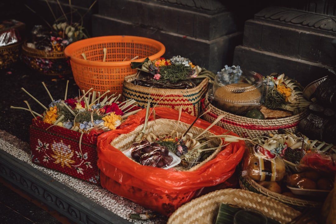 a table full of baskets of food, Balinese offerings