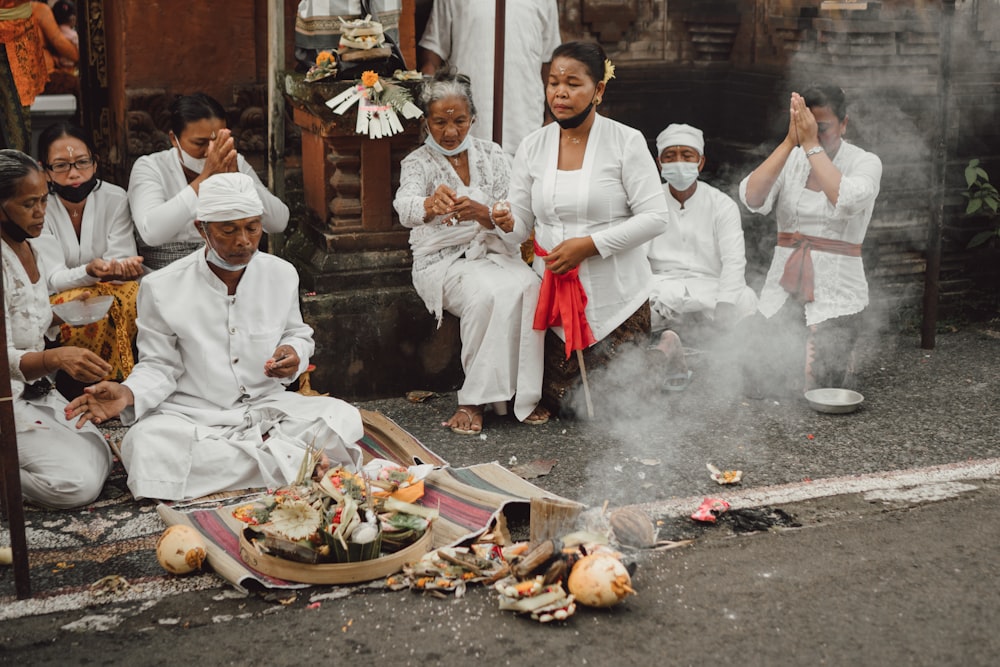 a group of people sitting on the ground