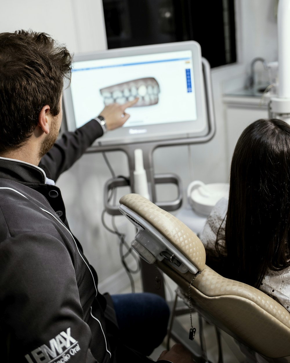 a man and a woman using a touch screen device