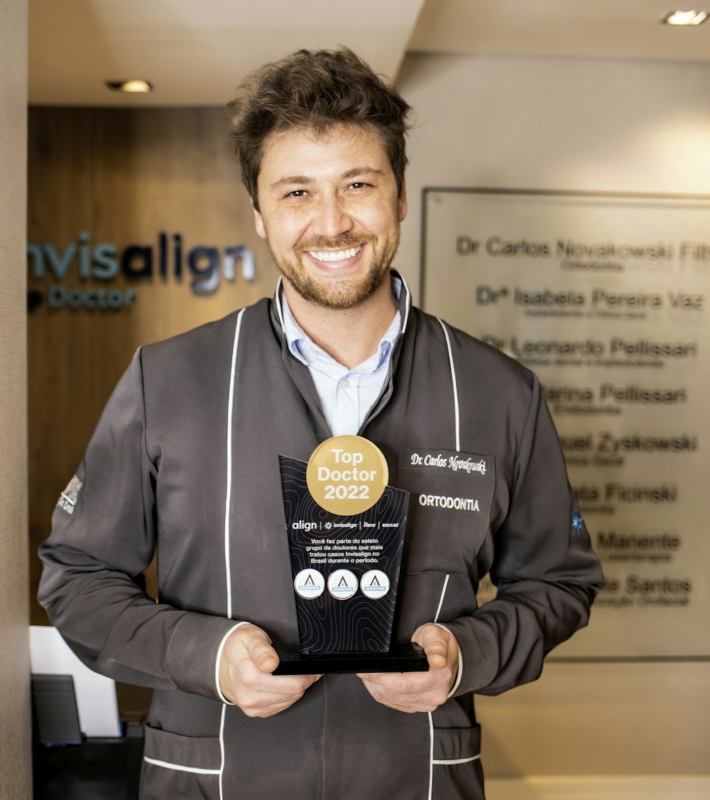 a man holding a medal