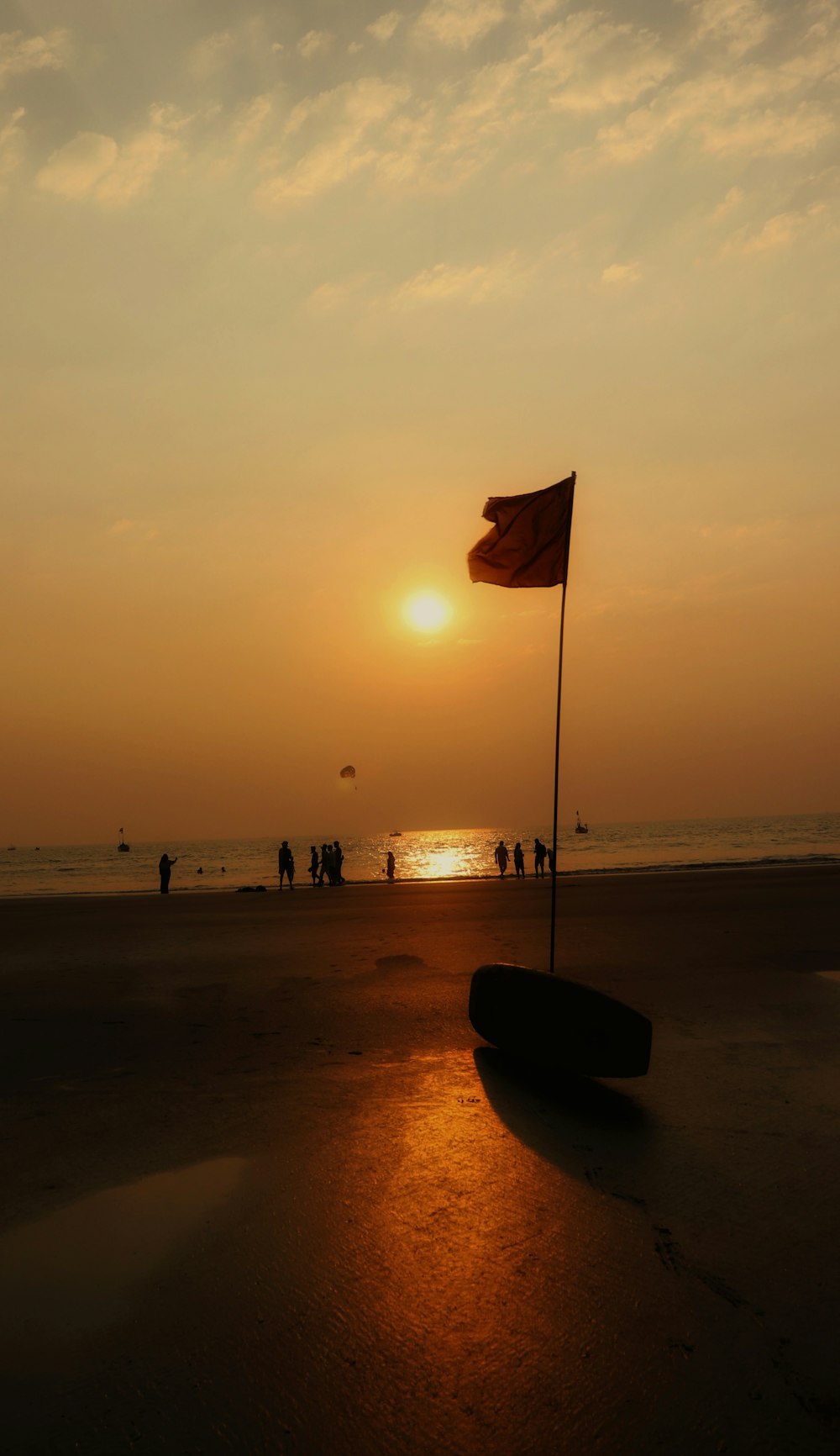 a flag on a pole on a beach