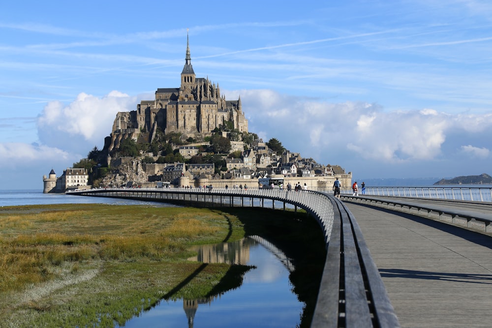 a castle on a hill with Mont Saint-Michel in the background