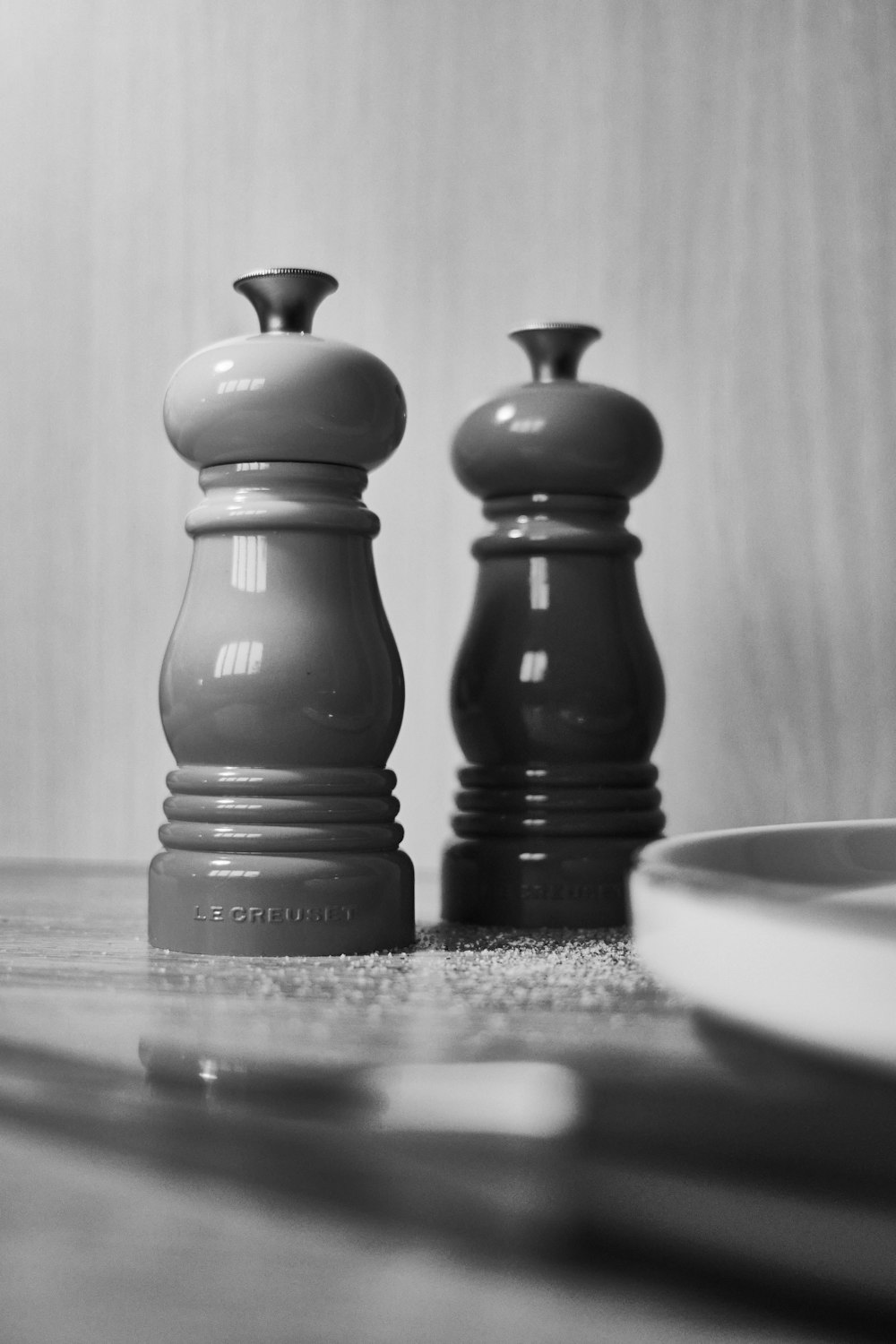 a couple of black and white chess pieces on a table