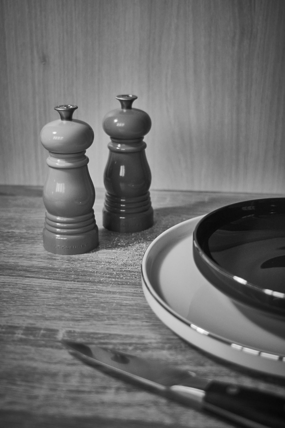 a table with a plate and a bowl and a knife