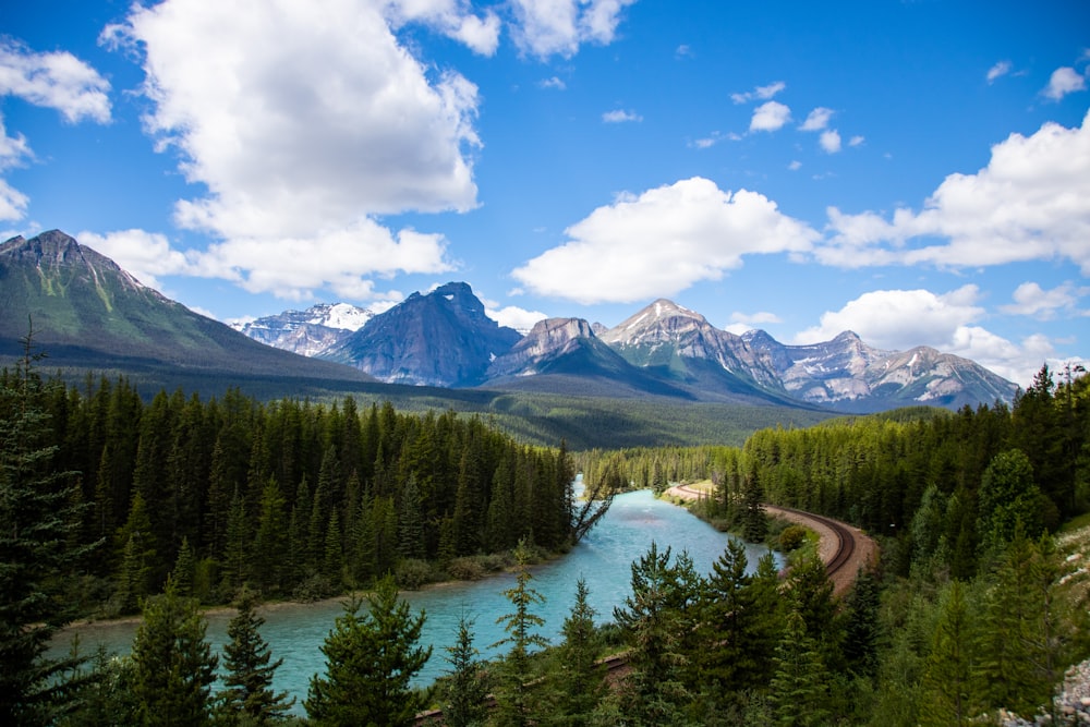 a river surrounded by trees and mountains