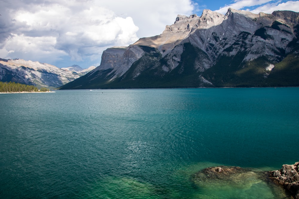 a body of water with mountains in the background