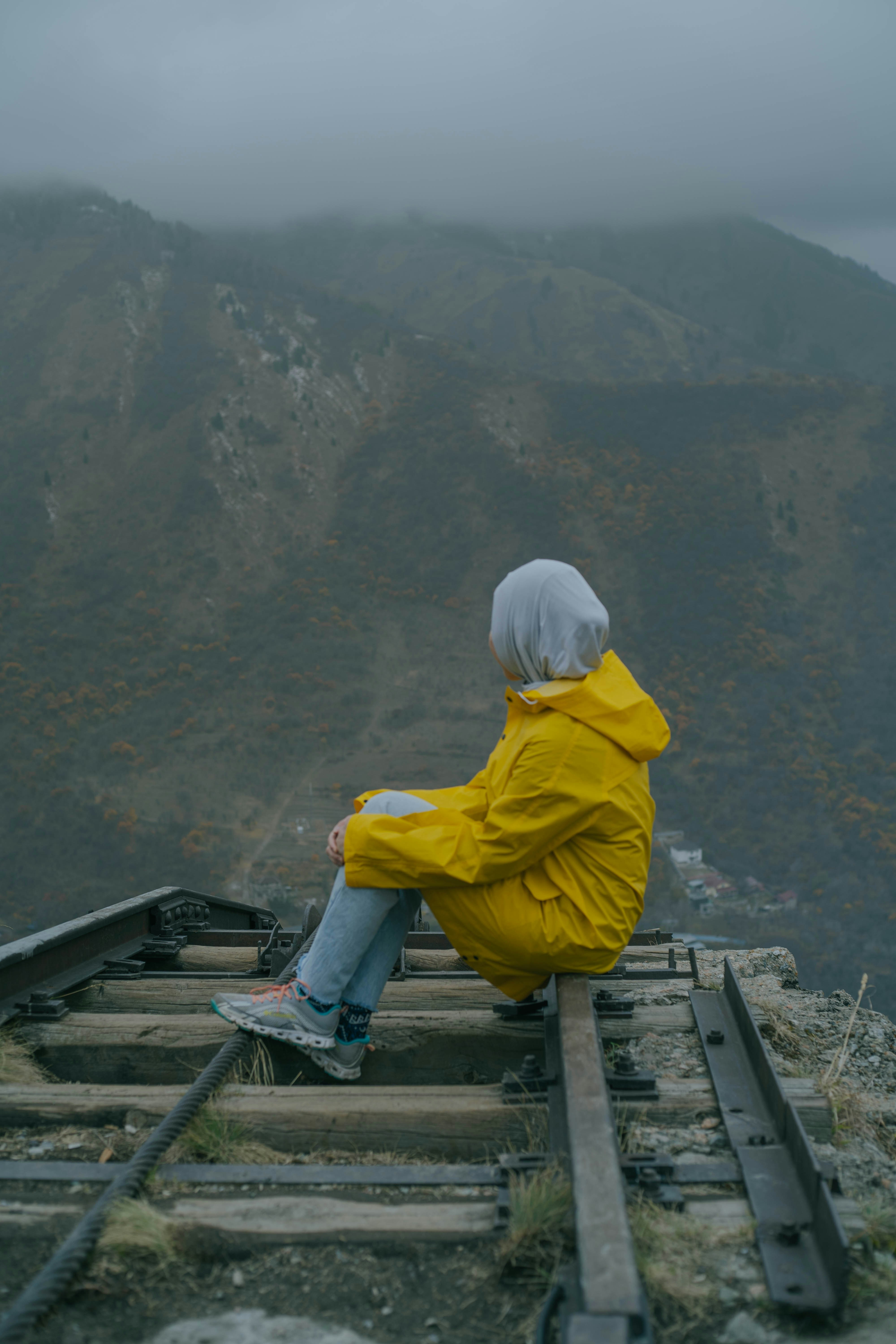 a person sitting on a rail