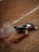 A close-up of a remote-controlled car on a racetrack.
