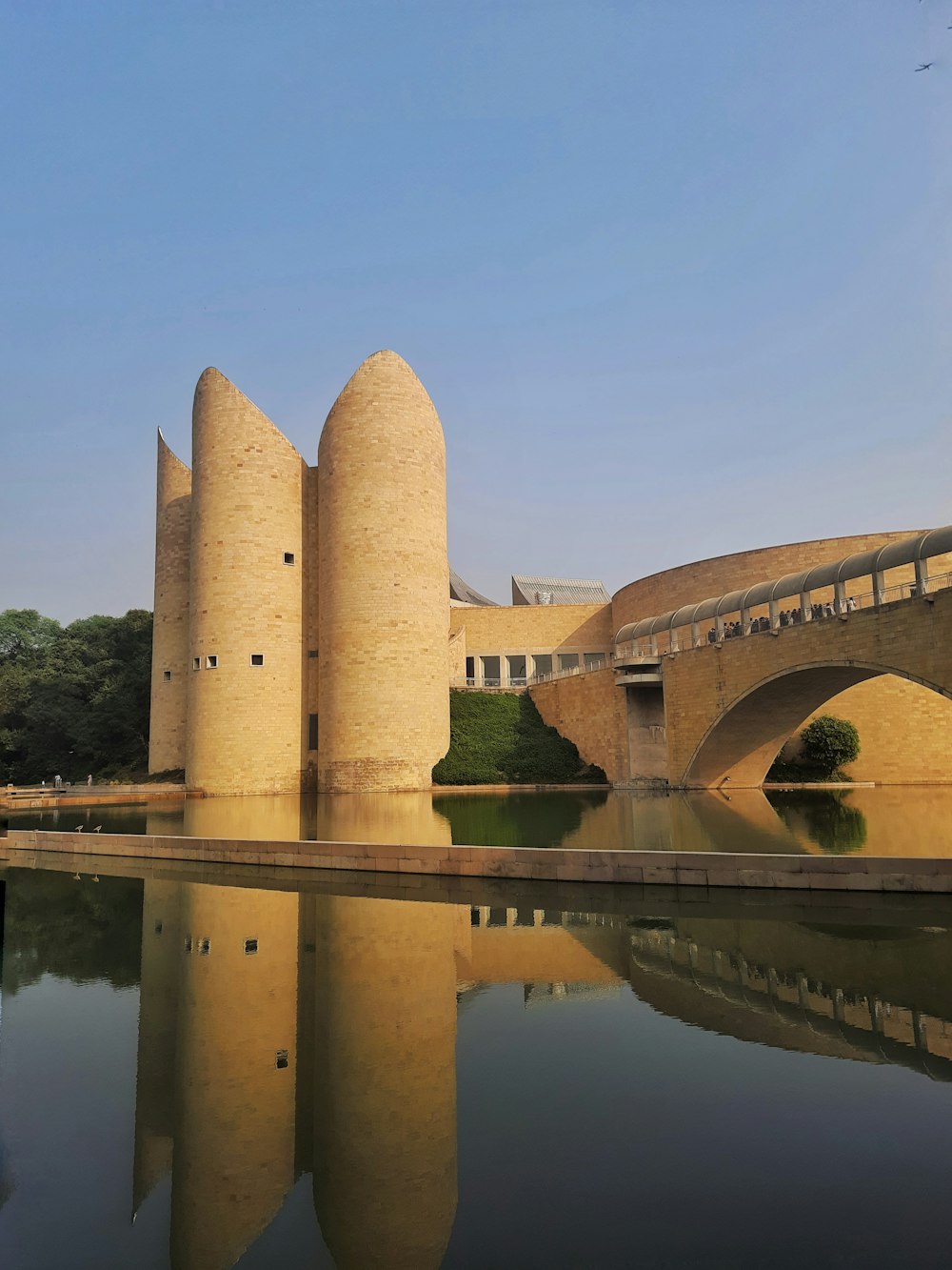 a stone building with a bridge over water