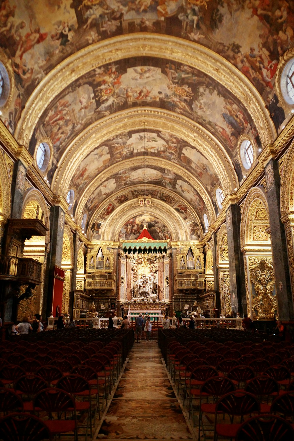 a large ornate building with a large ceiling and many seats