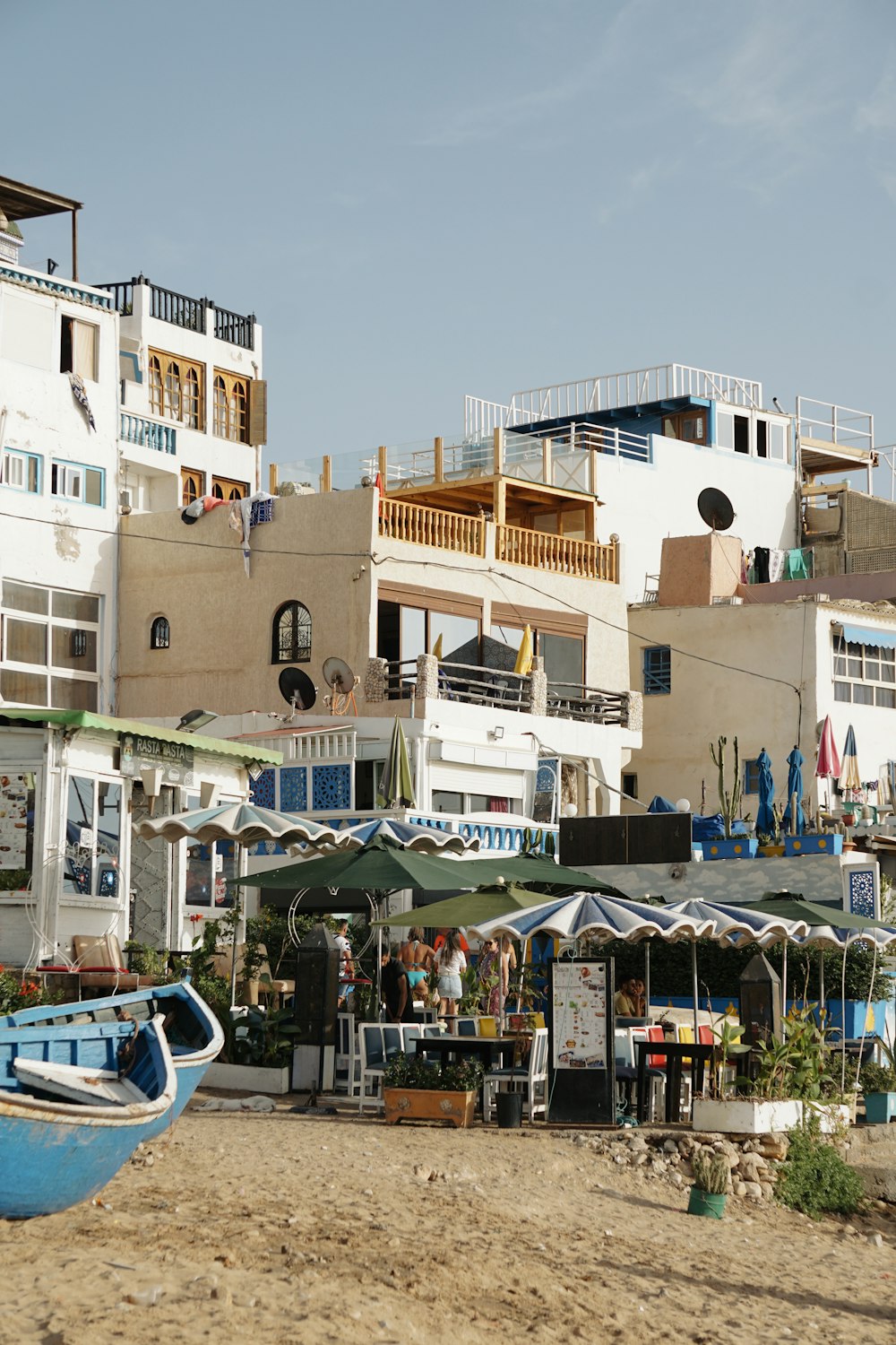 a group of buildings with a boat in front of them