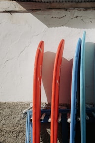 a group of paddles leaning against a wall