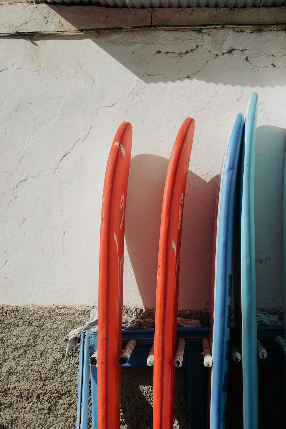 a group of paddles leaning against a wall