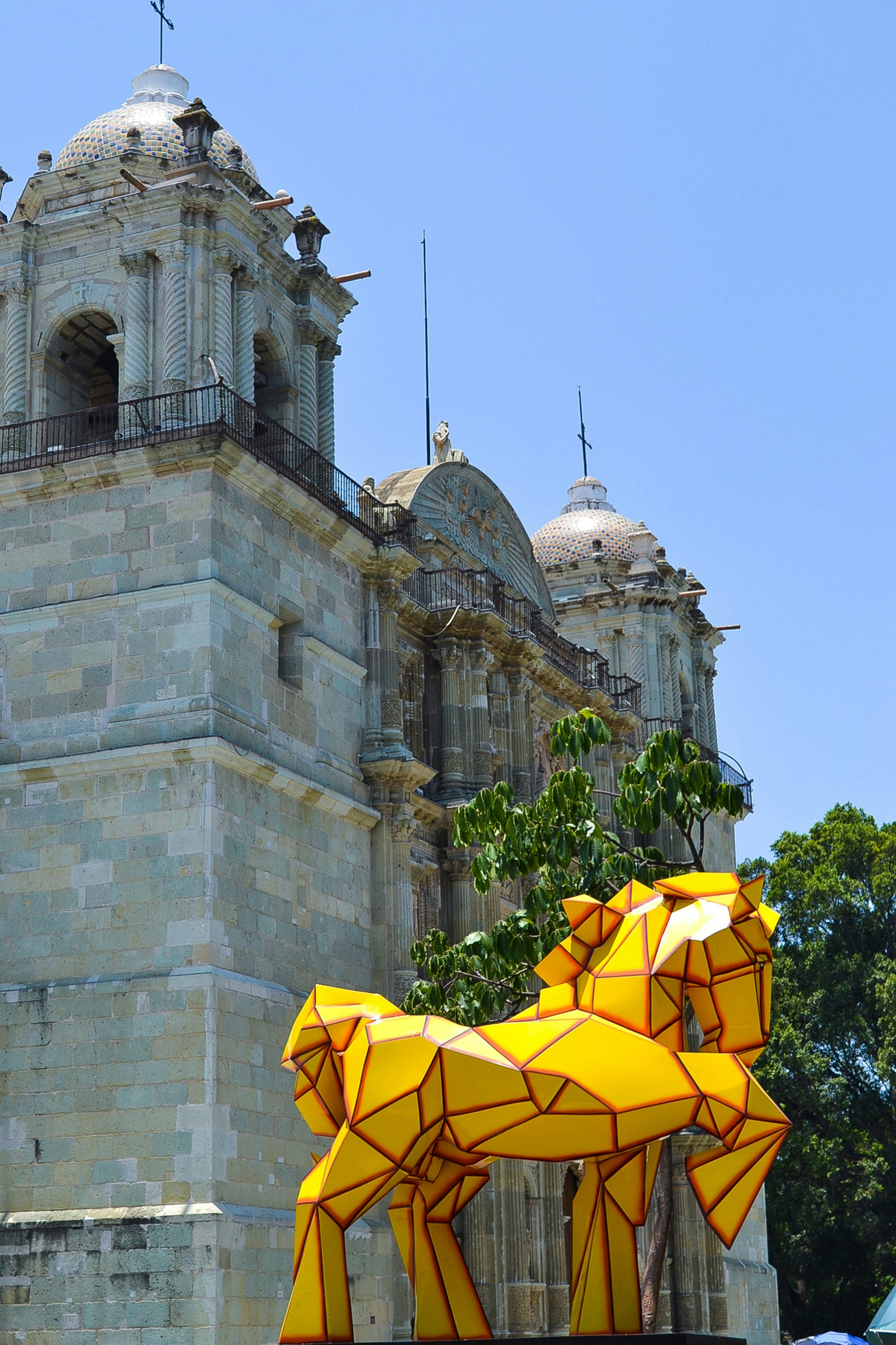 a group of yellow umbrellas in front of a building