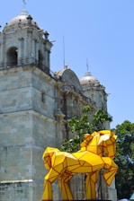 a group of yellow umbrellas in front of a building