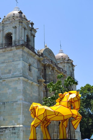 a group of yellow umbrellas in front of a building